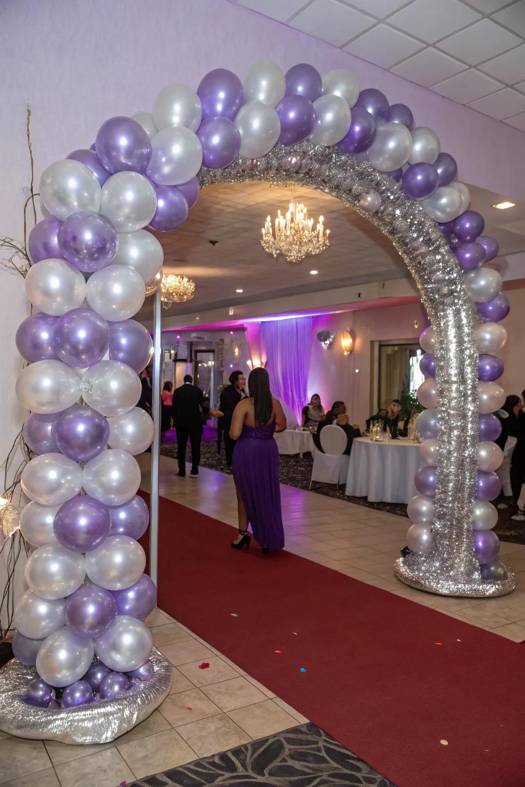 A stunning entryway with a lavender and silver balloon arch that welcomes guests in style.