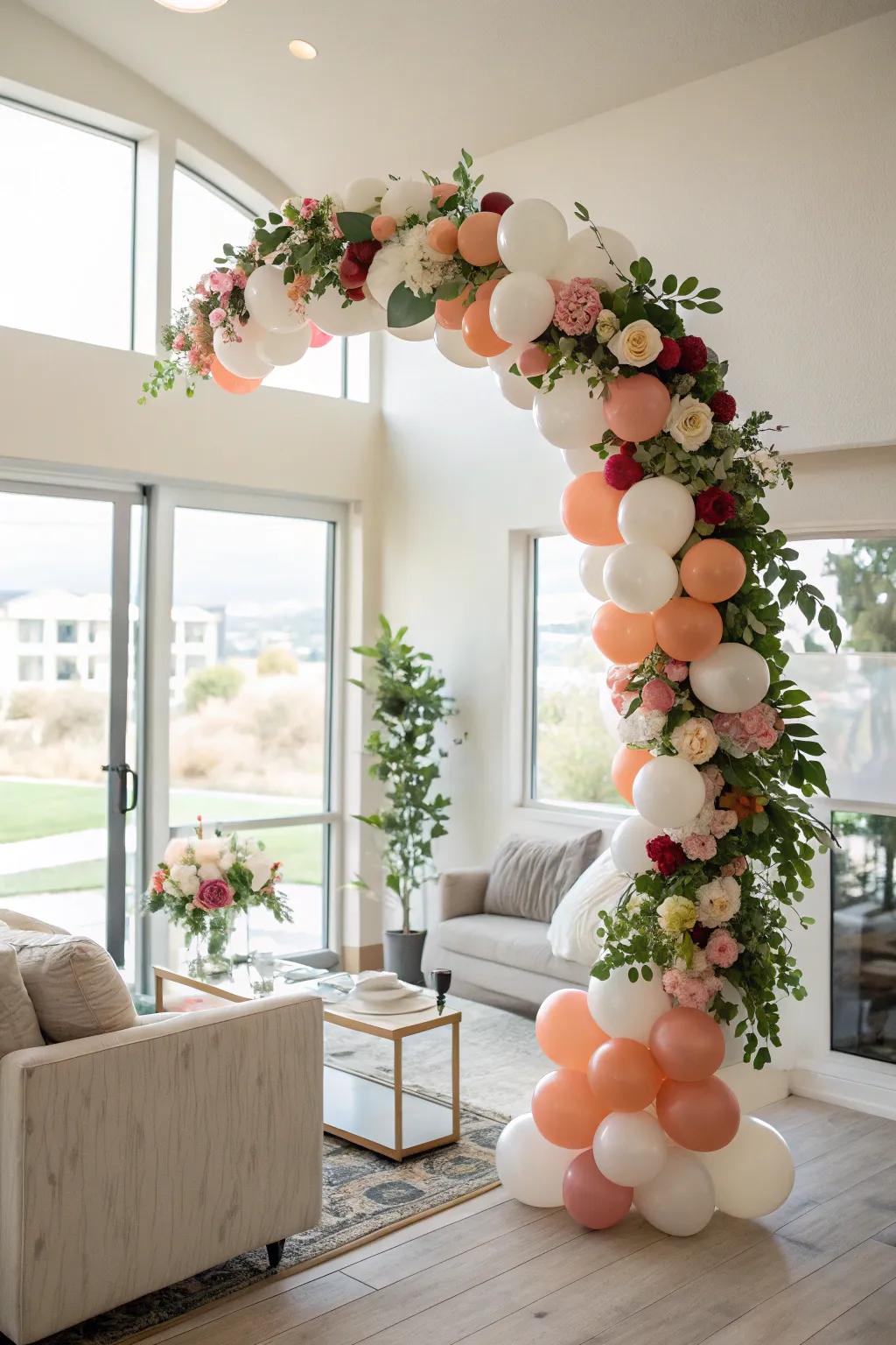 A balloon arch enhanced with floral details creates a stunning entrance.