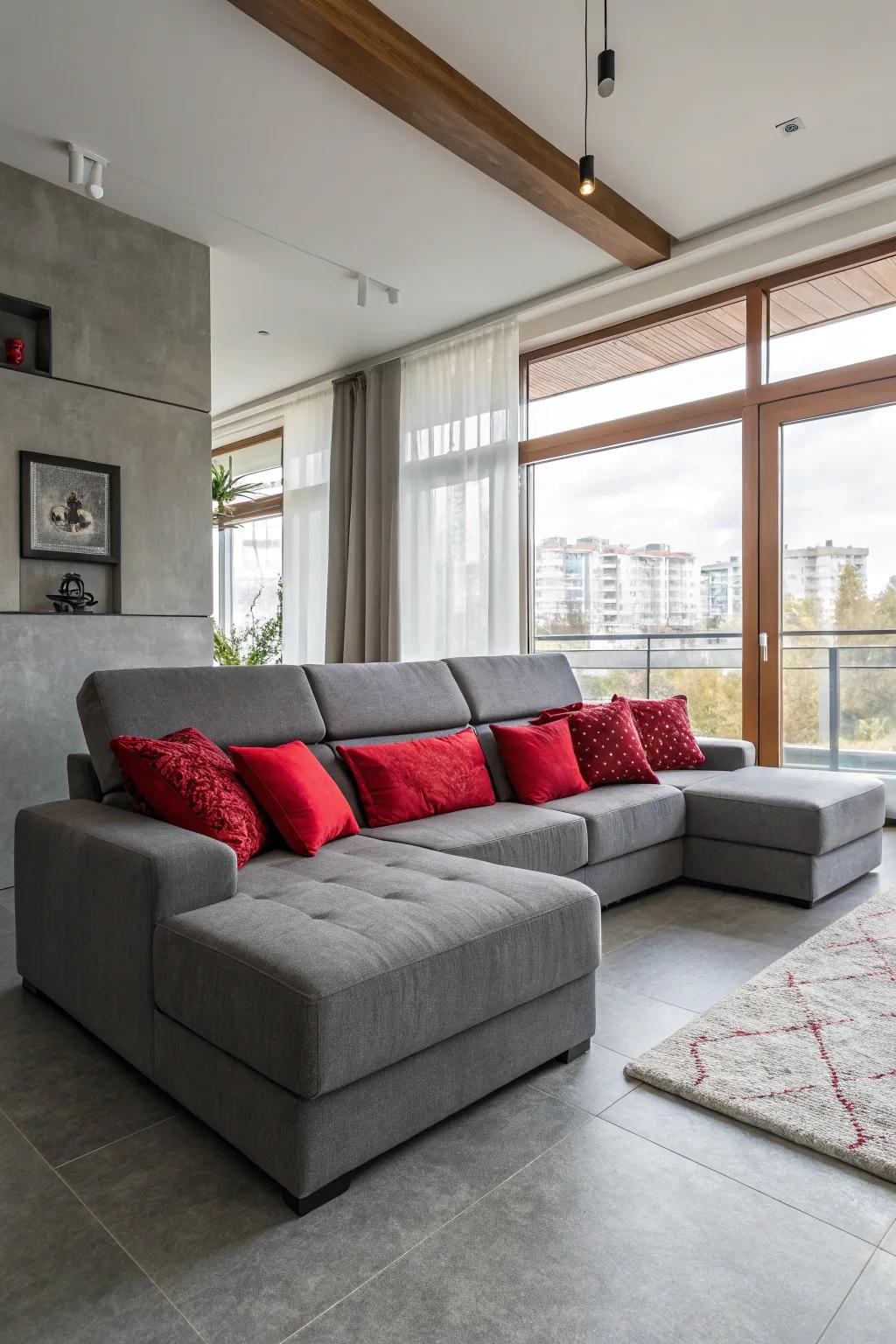 A welcoming living area showcasing a silver sectional and scarlet cushions.