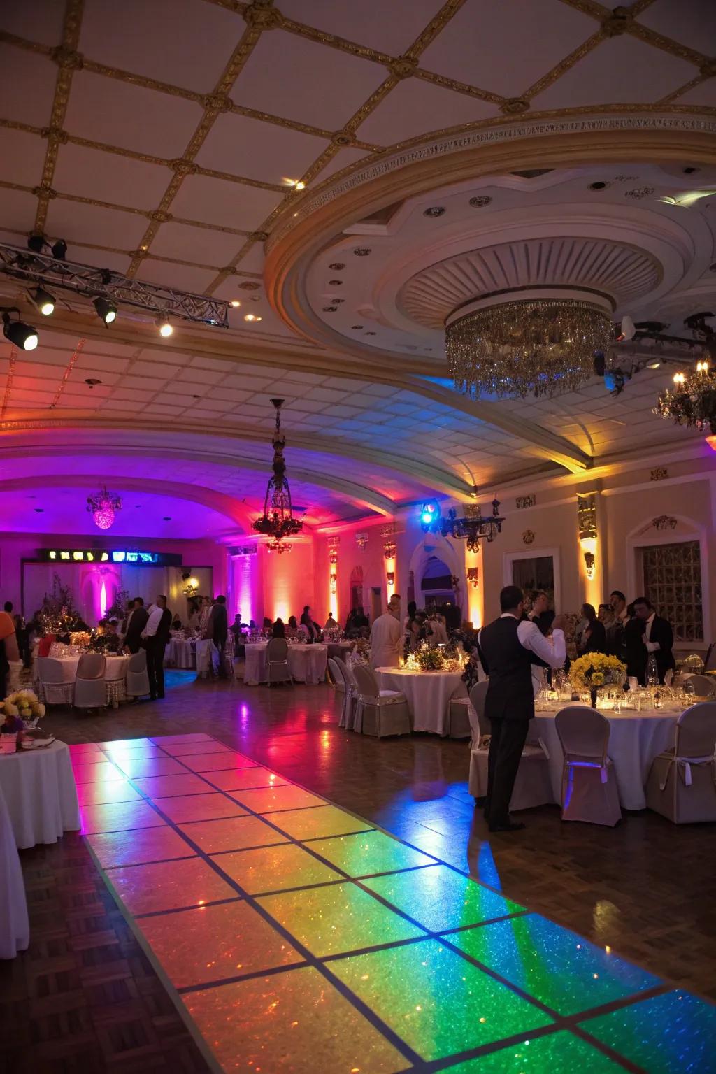A wedding reception venue exquisitely lit with rainbow illumination.