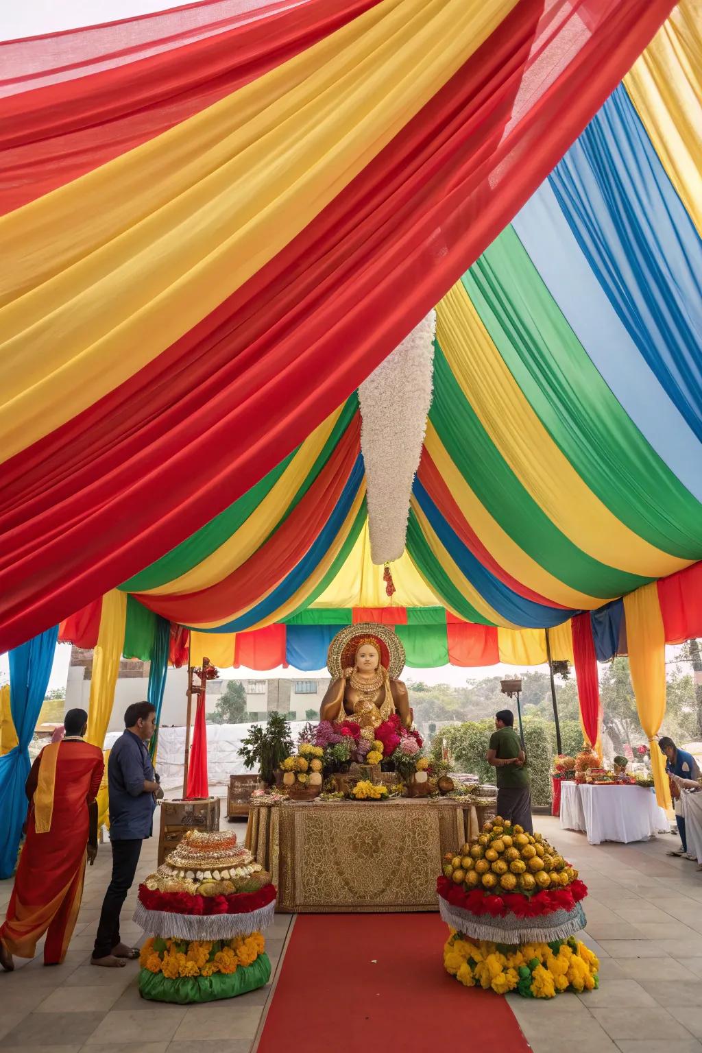 Dramatic and colorful drapes creating a canopy over the Ganesh Chaturthi setup.