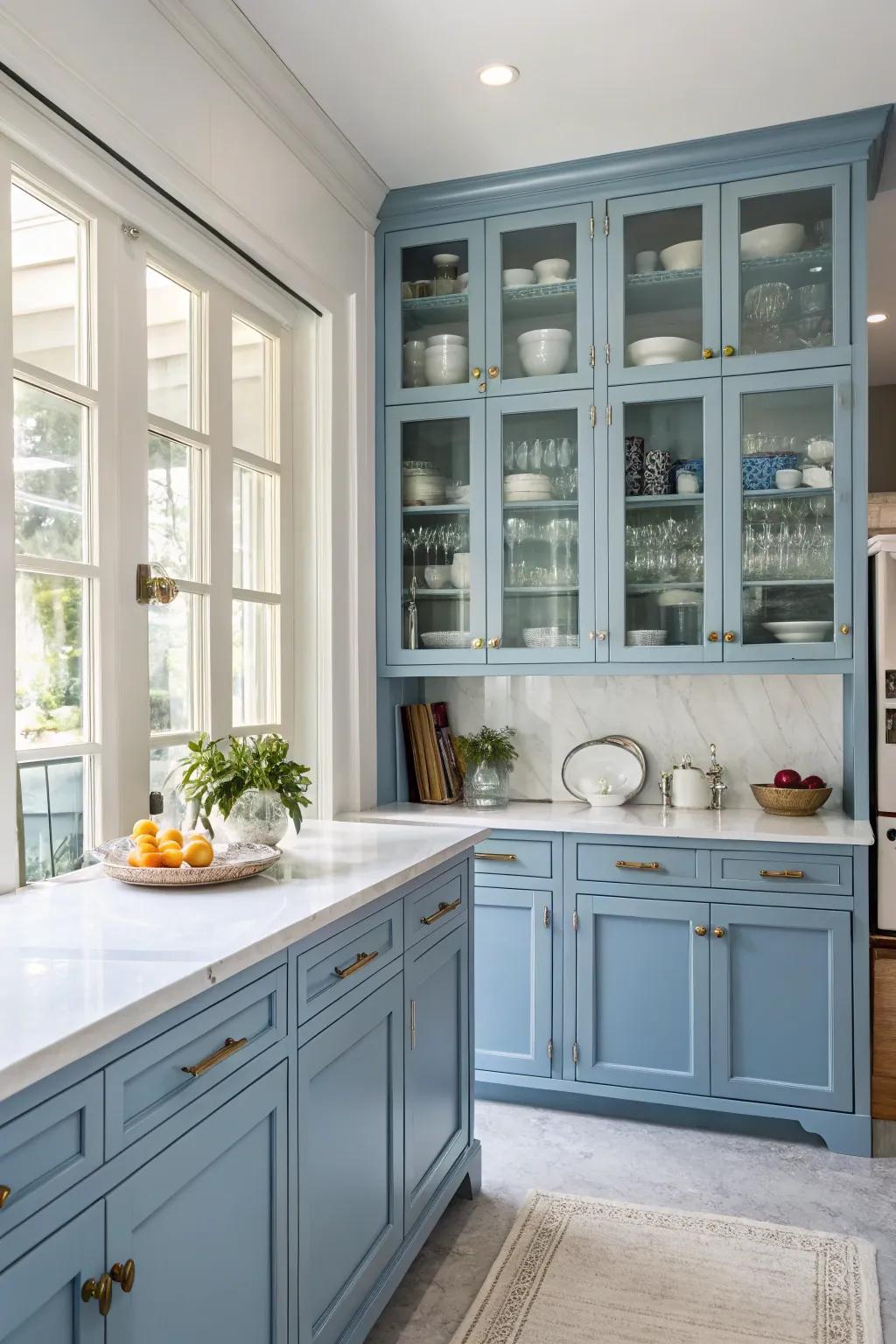 Elegant glass front blue cabinets display favorite dishware.