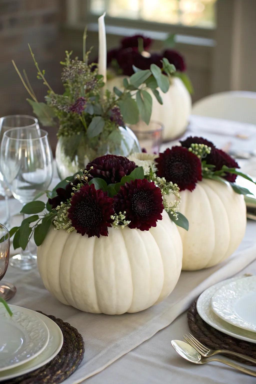 White pumpkins filled with flowers create a unique, thematic centerpiece.
