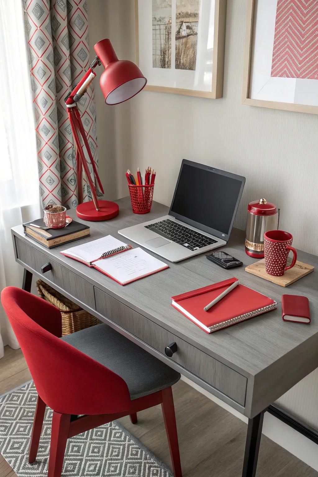 A home office featuring a silver desk and vibrant scarlet accessories.