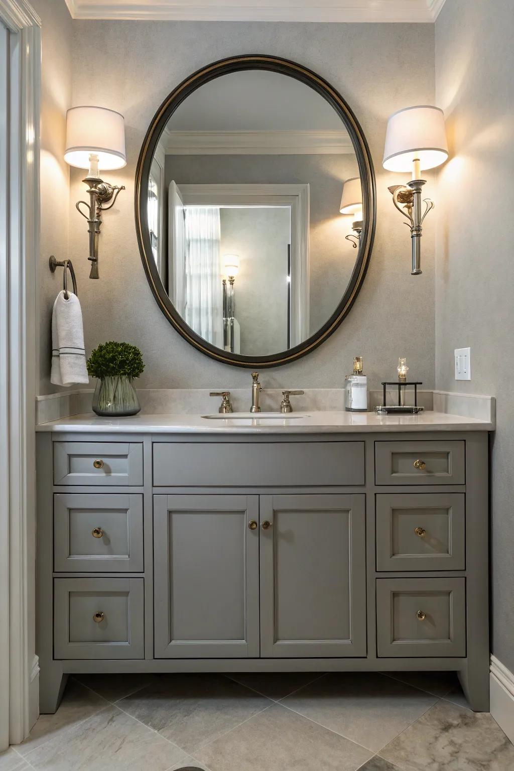 Elegant lighting and a round mirror elevate the look of the grey vanity.