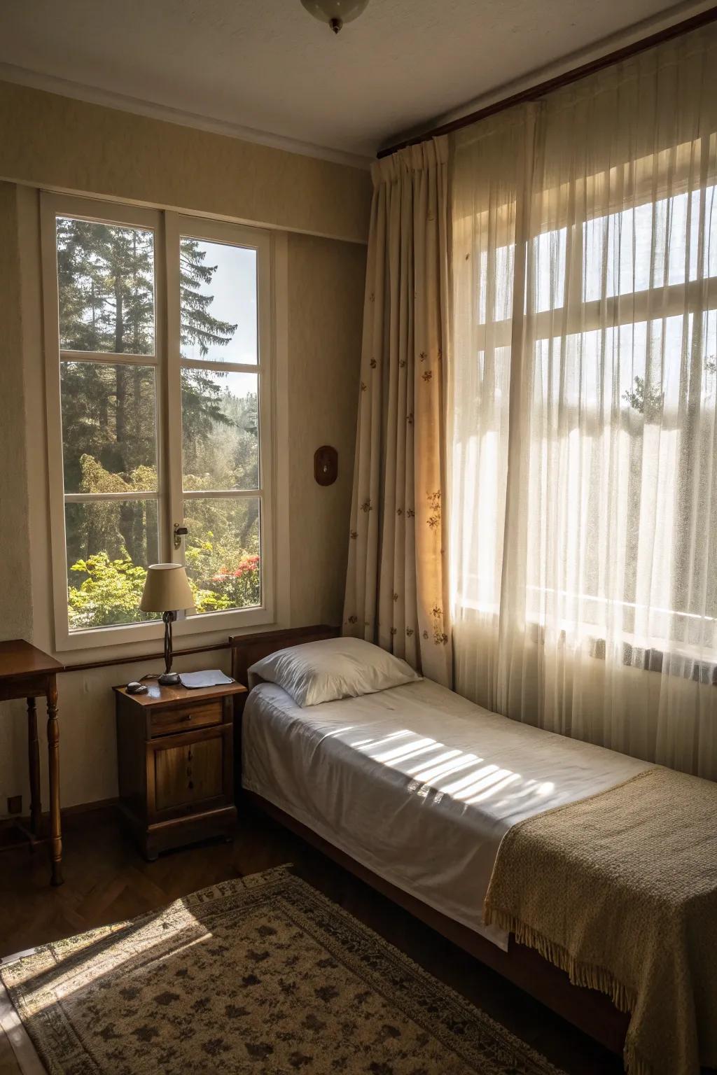 A small bedroom filled with natural light thanks to sheer curtains.