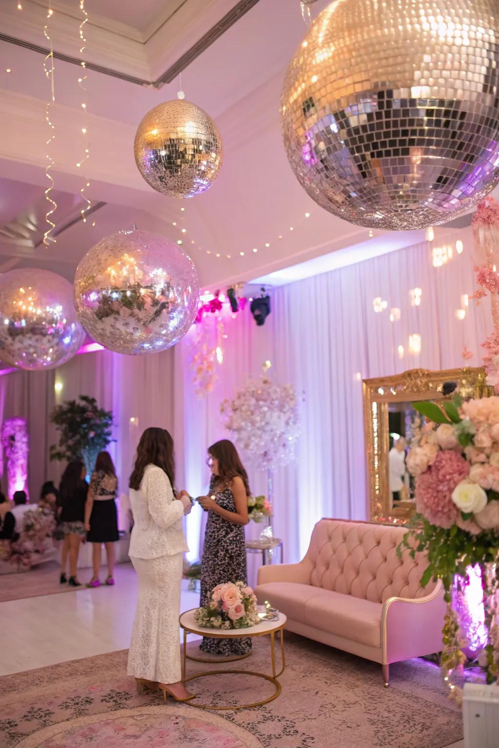 Mirror balls dramatically elevate the celebratory atmosphere with a glamorous shimmer.