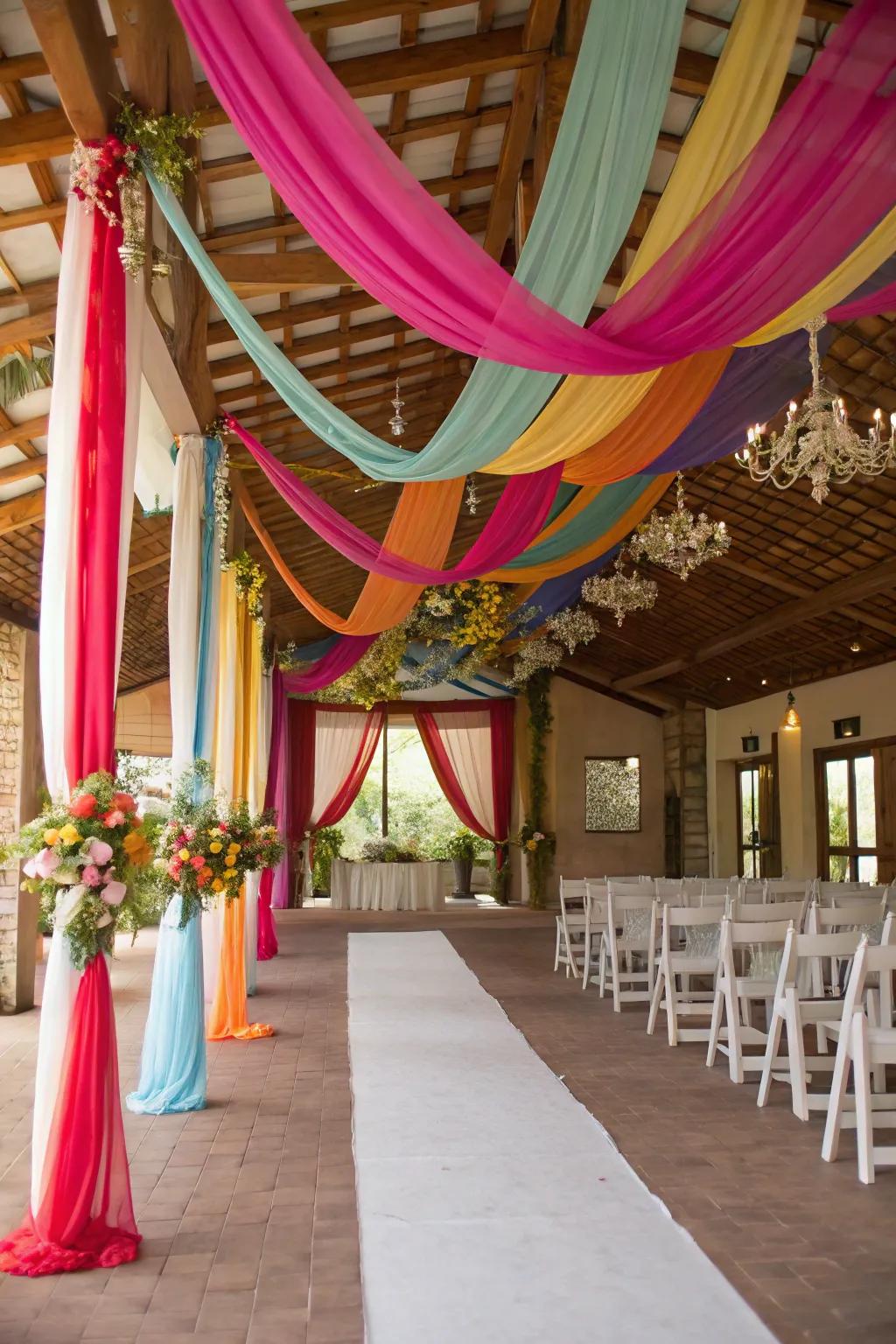 A wedding location lavishly decorated with vibrant rainbow cloth.