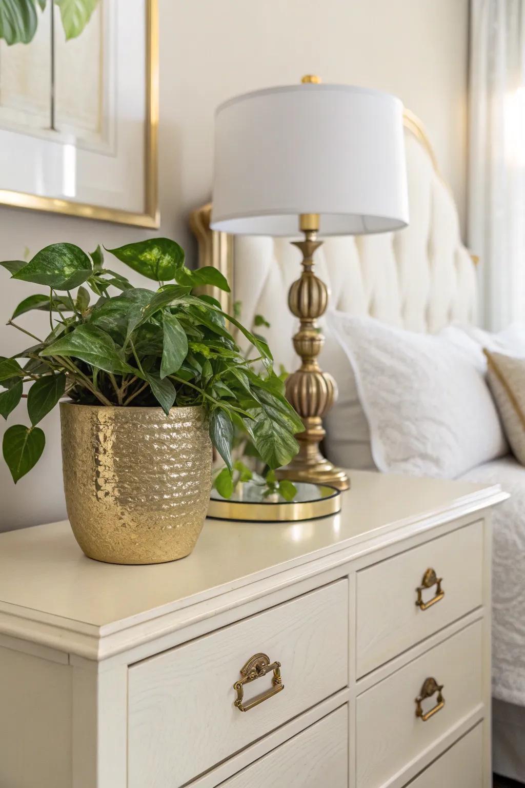 Greenery in a gold pot provides a revitalizing touch to the bedroom.