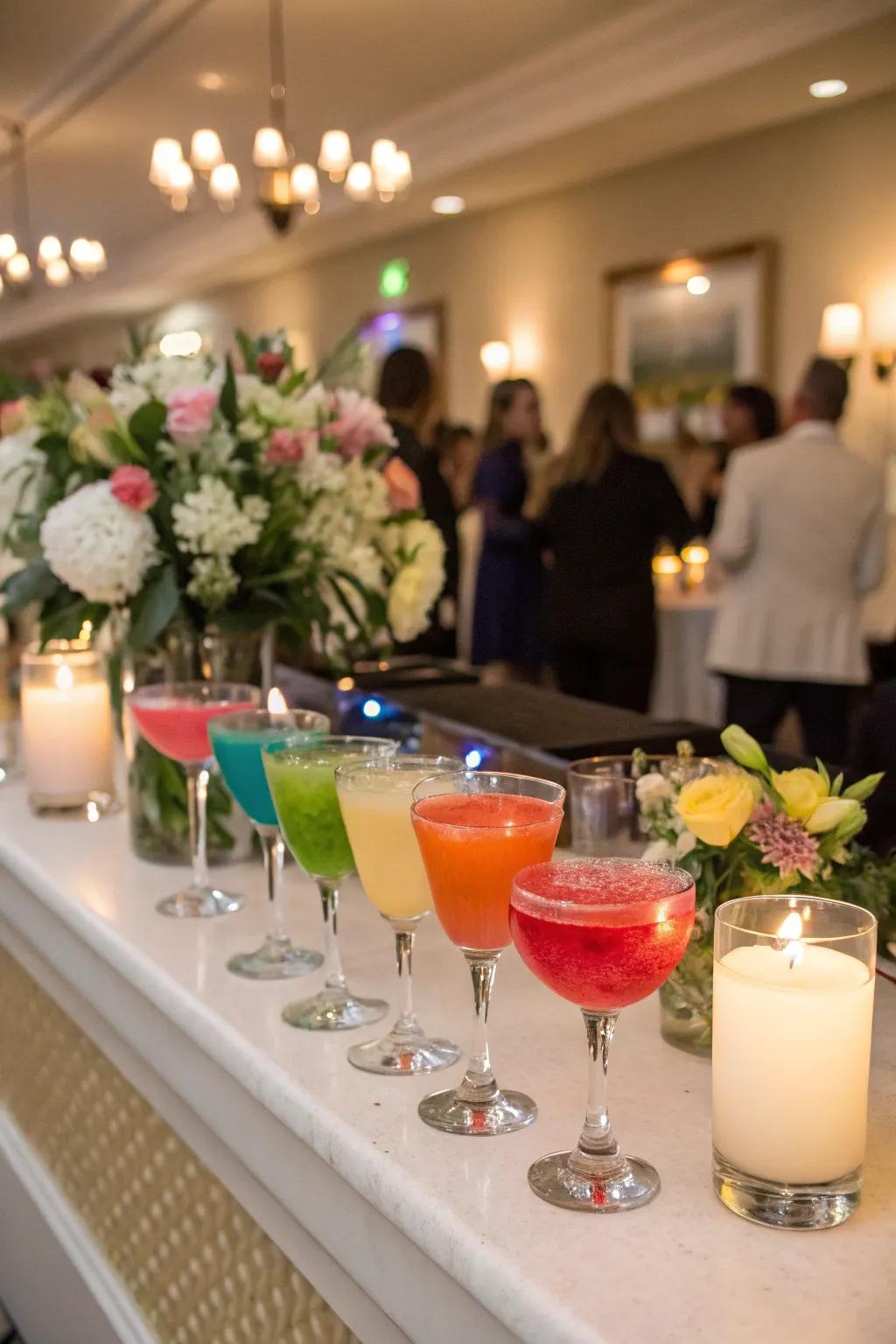 A collection of cocktails themed around the rainbow at a wedding reception.